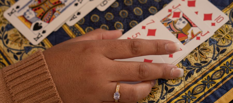 SANTA MARIA CAPUA, ITALY - Oct 18, 2020: Santa Maria Capua Vetere, Italy, October 18th 2020, The hands of a woman playing Rummy at home