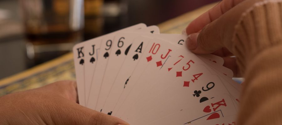 SANTA MARIA CAPUA VETERE, ITALY - Oct 29, 2020: Santa Maria Capua Vetere, Italy, October 18th 2020, The hands of a woman playing English cards