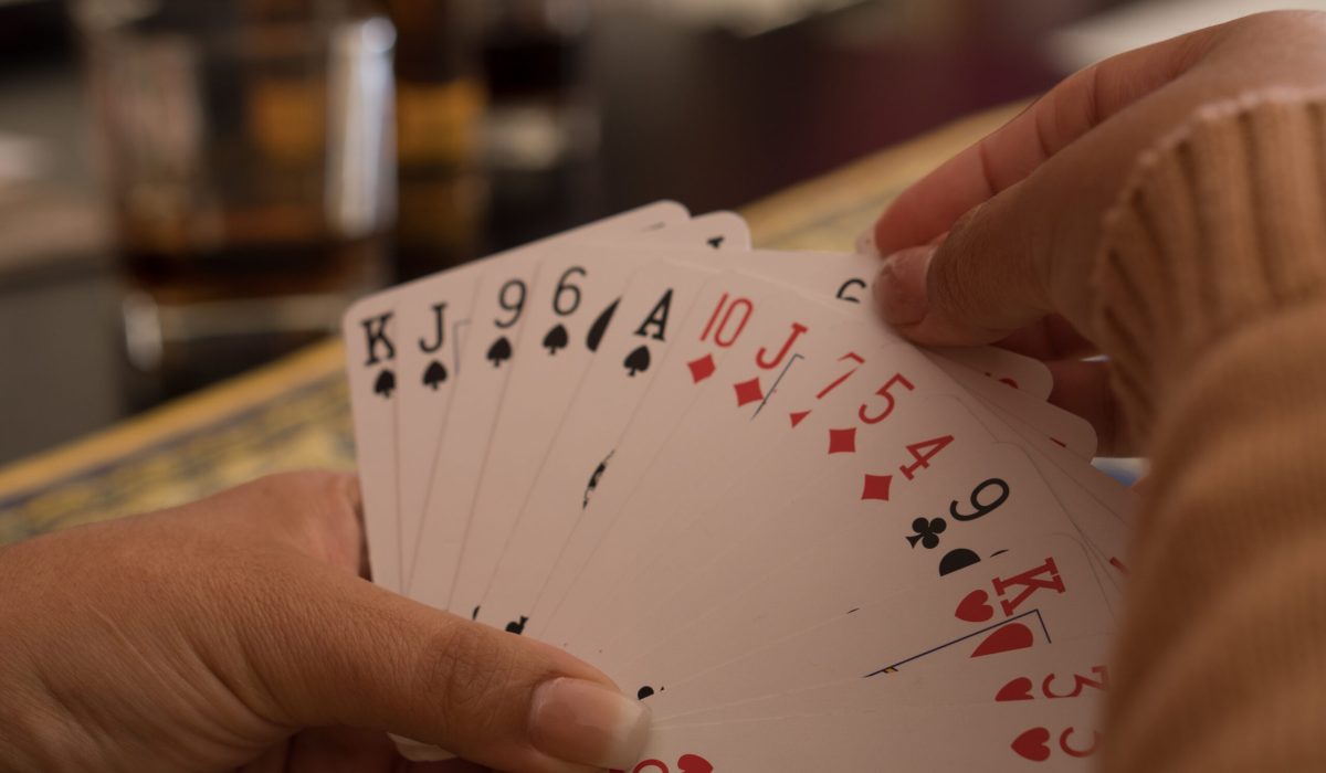 SANTA MARIA CAPUA VETERE, ITALY - Oct 29, 2020: Santa Maria Capua Vetere, Italy, October 18th 2020, The hands of a woman playing English cards